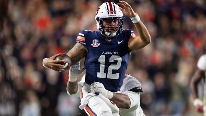 Auburn Tigers quarterback Ashton Daniels (12) runs the ball as Auburn Tigers take on Alabama Crimson Tide in the Iron Bowl at Jordan-Hare Stadium in Auburn, Ala. on Saturday, Nov. 29, 2025. Alabama Crimson Tide leads Auburn Tigers 17-6. Auburn Tigers quarterback Ashton Daniels (12) runs the ball as Auburn Tigers take on Alabama Crimson Tide in the Iron Bowl at Jordan-Hare Stadium in Auburn, Ala. on Saturday, Nov. 29, 2025. Alabama Crimson Tide leads Auburn Tigers 17-6.