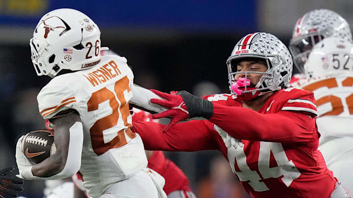 Ohio State Buckeyes defensive end JT Tuimoloau (44) tries to bring down Texas Longhorns running back Quintrevion Wisner (26) in the third quarter of the Cotton Bowl Classic during the College Football Playoff semifinal game at AT&T Stadium in Arlington, Texas on January, 10, 2025. Ohio State Buckeyes defensive end JT Tuimoloau (44) tries to bring down Texas Longhorns running back Quintrevion Wisner (26) in the third quarter of the Cotton Bowl Classic during the College Football Playoff semifinal game at AT&T Stadium in Arlington, Texas on January, 10, 2025.