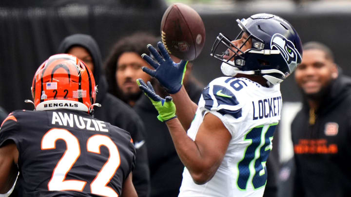 Seattle Seahawks wide receiver Tyler Lockett (16) catches a pass along the sideline as Cincinnati Bengals cornerback Chidobe Awuzie (22) defends in the second quarter during an NFL football game between the Seattle Seahawks and the Cincinnati Bengals Sunday, Oct. 15, 2023, at Paycor Stadium in Cincinnati.