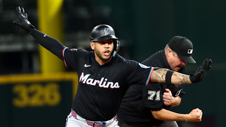 Miami Marlins designated hitter Agustin Ramirez (50) is initially called out at second base by umpire Jordan Baker (71) but had the call overturned during the third inning against the Texas Rangers at Globe Life Field. 