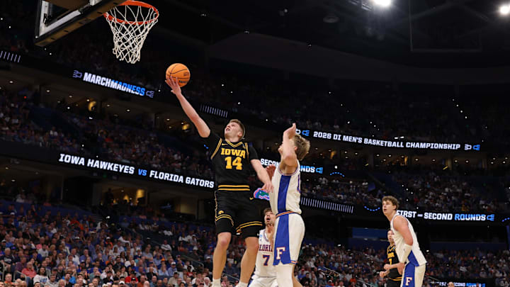 Mar 22, 2026; Tampa, FL, USA; Iowa Hawkeyes guard Bennett Stirtz (14) shoots the ball past Florida Gators forward Thomas Haugh (10) in the first half during a second round game of the men's 2026 NCAA Tournament at Benchmark International Arena. Mandatory Credit: Matt Pendleton-Imagn Images