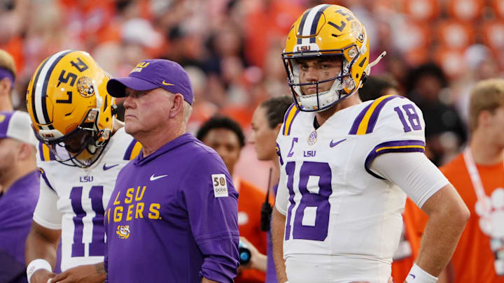 Aug 30, 2025; Clemson, South Carolina, USA; LSU Tigers head coach Brian Kelly and quarterback Garrett Nussmeier (18) look on during warmups before the game against the Clemson Tigers at Memorial Stadium. Mandatory Credit: Ken Ruinard-USA TODAY Network via Imagn Images