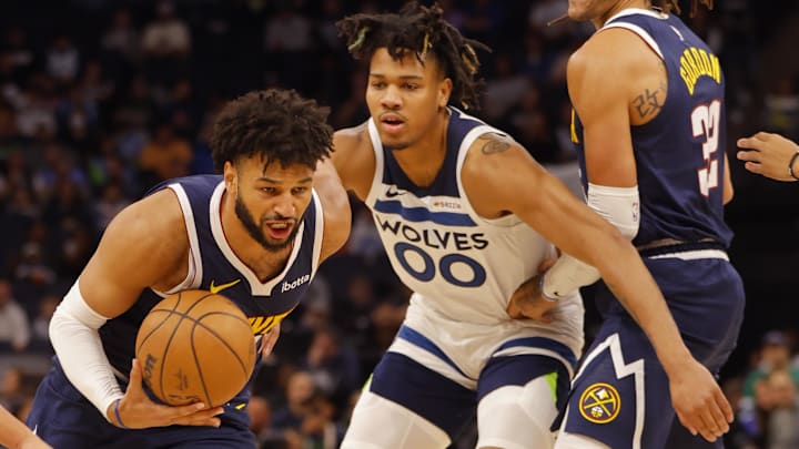 Oct 17, 2024; Minneapolis, Minnesota, USA; Denver Nuggets guard Jamal Murray (27) drives past Minnesota Timberwolves guard Terrence Shannon Jr. (00) in the first quarter at Target Center. Oct 17, 2024; Minneapolis, Minnesota, USA; Denver Nuggets guard Jamal Murray (27) drives past Minnesota Timberwolves guard Terrence Shannon Jr. (00) in the first quarter at Target Center.