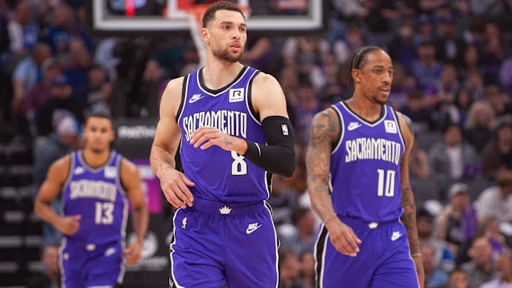 Feb 24, 2025; Sacramento, California, USA; Sacramento Kings guard Zach LaVine (8) and forward DeMar DeRozan (10) and forward Keegan Murray (13) walk up the court during the first quarter against the Charlotte Hornets at Golden 1 Center. Mandatory Credit: Ed Szczepanski-Imagn Images