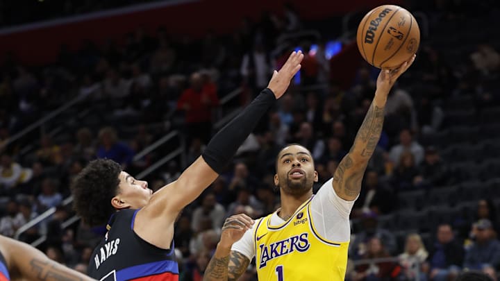 Nov 29, 2023; Detroit, Michigan, USA; Los Angeles Lakers guard D'Angelo Russell (1) shoots on Detroit Pistons guard Killian Hayes (7) in the first half at Little Caesars Arena. Mandatory Credit: Rick Osentoski-Imagn Images