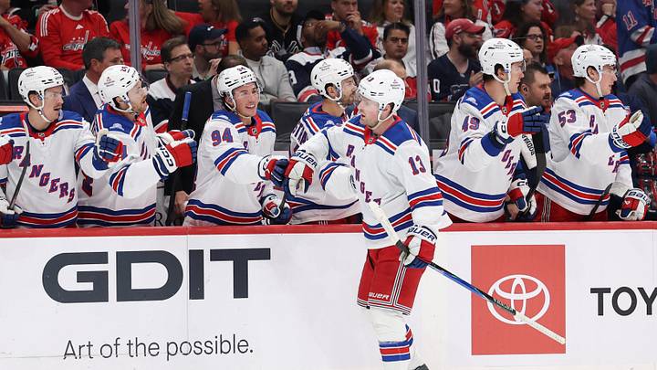 Oct 9, 2026; Washington, District of Columbia, USA; New York Rangers left wing Alexis Lafrenière (13) celebrates with teammates after scoring a goal against the Washington Capitals during the first period at Capital One Arena. Mandatory Credit: Geoff Burke-Imagn Images