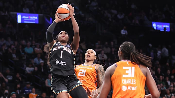 May 9, 2025; Brooklyn, NY, USA;  New York Marquesha Davis (1) drives past Connecticut Sun guard Marina Mabrey (3) and forward Robyn Parks (21) in the second quarter at Barclays Center. Mandatory Credit: Wendell Cruz-Imagn Images