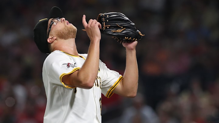 Aug 9, 2025; Pittsburgh, Pennsylvania, USA;  Pittsburgh Pirates relief pitcher Cam Sanders (64) reacts after pitching a scoreless ninth inning against the Cincinnati Reds at PNC Park. Mandatory Credit: Charles LeClaire-Imagn Images