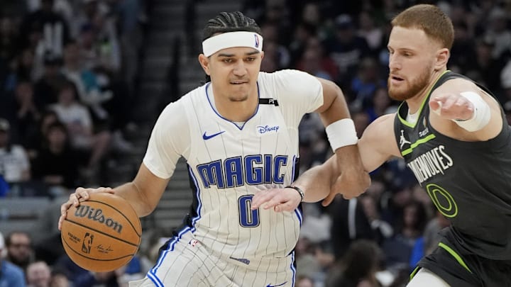 Orlando Magic guard Anthony Black works around Minnesota Timberwolves guard Donte DiVincenzo in the third quarter at Target Center in Minneapolis on March 14, 2025.