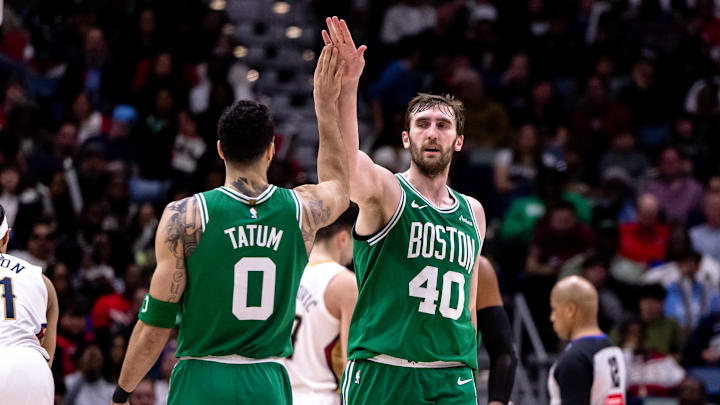 Jan 31, 2025; New Orleans, Louisiana, USA;  Boston Celtics center Luke Kornet (40) slaps hands with forward Jayson Tatum (0) after dunking the ball against the New Orleans Pelicans during the second half at Smoothie King Center. Mandatory Credit: Stephen Lew-Imagn Images