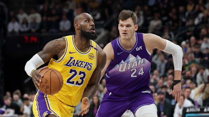Feb 12, 2025; Salt Lake City, Utah, USA; Los Angeles Lakers forward LeBron James (23) dribbles past Utah Jazz center Walker Kessler (24) during the first quarter at Delta Center. Mandatory Credit: Chris Nicoll-Imagn Images Feb 12, 2025; Salt Lake City, Utah, USA; Los Angeles Lakers forward LeBron James (23) dribbles past Utah Jazz center Walker Kessler (24) during the first quarter at Delta Center. Mandatory Credit: Chris Nicoll-Imagn Images