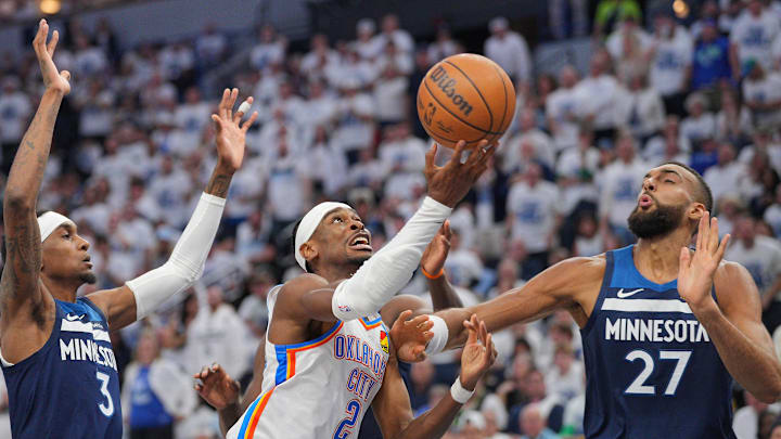 May 24, 2025; Minneapolis, Minnesota, USA; Oklahoma City Thunder guard Shai Gilgeous-Alexander (2) shoots the ball over Minnesota Timberwolves center Rudy Gobert (27) during the first half in game three of the western conference finals for the 2025 NBA Playoffs at Target Center. Mandatory Credit: Brad Rempel-Imagn Images