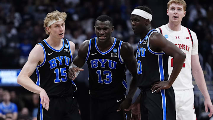 Mar 22, 2025; Denver, CO, USA; Brigham Young Cougars center Keba Keita (13) reacts with forward Richie Saunders (15) and forward Mawot Mag (0) during the first half in the second round of the NCAA Tournament  at Ball Arena. Mandatory Credit: Ron Chenoy-Imagn Images