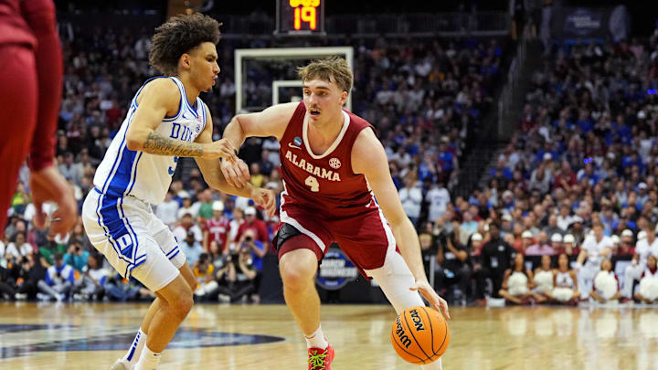 Mar 29, 2025; Newark, NJ, USA; Alabama Crimson Tide forward Grant Nelson (4) drives to the basket against Duke Blue Devils guard Tyrese Proctor (5) during the first half in the East Regional final of the 2025 NCAA tournament at Prudential Center. Mandatory Credit: Robert Deutsch-Imagn Images