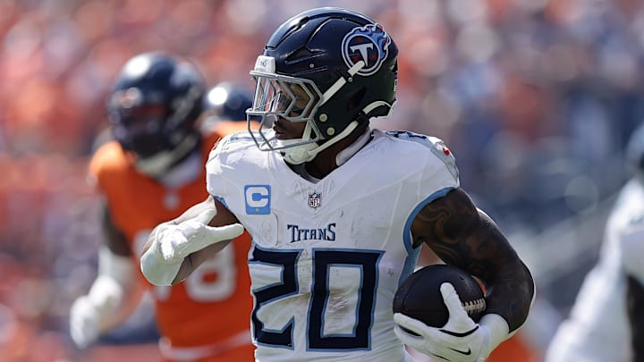 Sep 7, 2025; Denver, Colorado, USA;Tennessee Titans running back Tony Pollard (20) rushes the ball against the Denver Broncos in the first half at Empower Field at Mile High. Mandatory Credit: Isaiah J. Downing-Imagn Images