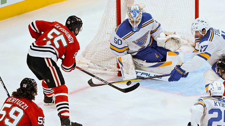 Jan 7, 2026; Chicago, Illinois, USA;  St. Louis Blues goaltender Jordan Binnington (50) defends against Chicago Blackhawks defenseman Artyom Levshunov (55)  during the third period at the United Center. Mandatory Credit: Matt Marton-Imagn Images