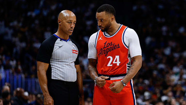Apr 21, 2025; Denver, Colorado, USA; Los Angeles Clippers guard Norman Powell (24) talks with referee Marc Davis (8) in the third quarter against the Denver Nuggets during game two of first round for the 2025 NBA Playoffs at Ball Arena. Mandatory Credit: Isaiah J. Downing-Imagn Images