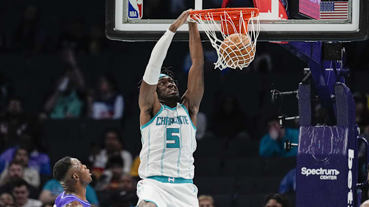 Mar 31, 2025; Charlotte, North Carolina, USA; Charlotte Hornets center Mark Williams (5) gets a dunk over Utah Jazz center Oscar Tshiebwe (34) during the second half at Spectrum Center. Mandatory Credit: Jim Dedmon-Imagn Images