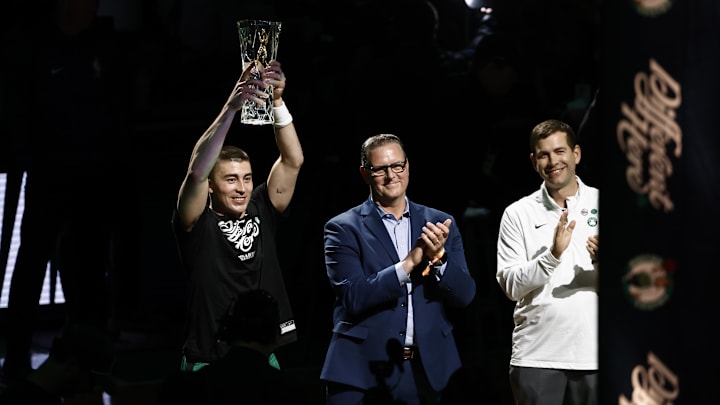 Apr 23, 2025; Boston, Massachusetts, USA; Boston Celtics guard Payton Pritchard (11) holds up the 2025 NBA Sixth Man Award as Celtics president of basketball operations Brad Stevens, right, applauds before game two of the first round of the 2024 NBA Playoffs between the Boston Celtics and the Orlando Magic at TD Garden. Mandatory Credit: Winslow Townson-Imagn Images