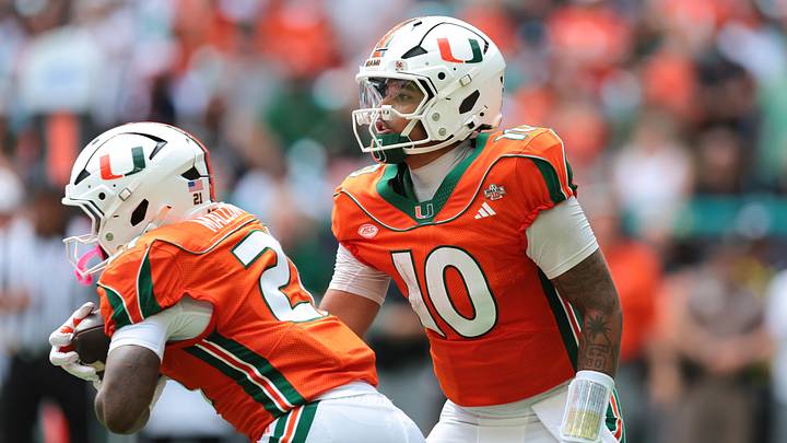 Oct 24, 2026; Miami Gardens, Florida, USA; Miami Hurricanes quarterback Darian Mensah (10) handoff the football to running back Javian Mallory (21) during the first quarter at Hard Rock Stadium. Mandatory Credit: Sam Navarro-Imagn Images