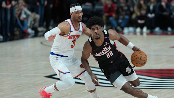 Mar 12, 2025; Portland, Oregon, USA: Portland Trail Blazers guard Scoot Henderson (00) dribbles the ball against New York Knicks shooting guard Josh Hart (3) during overtime at Moda Center. Mandatory Credit: Soobum Im-Imagn Images