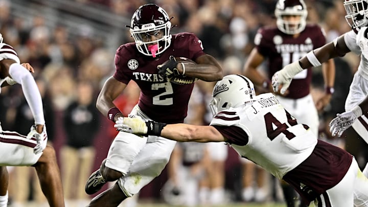 Texas A&M Aggies running back Rueben Owens (2) runs the ball during the second half as Mississippi State Bulldogs linebacker Jett Johnson (44) defends at Kyle Field. 