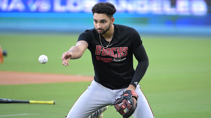 Oct 6, 2023; Los Angeles, CA, USA;  Arizona Diamondbacks shortstop Jordan Lawlar (10) fields a ball during the NLDS workouts at Dodgers Stadium. Mandatory Credit: Jayne Kamin-Oncea-Imagn Images