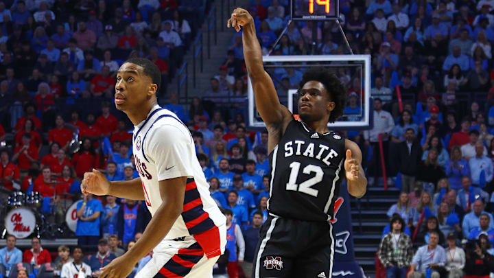 Feb 15, 2025; Oxford, Mississippi, USA; Mississippi State Bulldogs guard Josh Hubbard (12) holds after shooting for three over Mississippi Rebels guard Matthew Murrell (11) during the first half at The Sandy and John Black Pavilion at Ole Miss. Mandatory Credit: Petre Thomas-Imagn Images