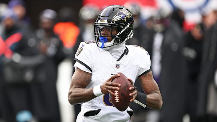 Dec 15, 2024; East Rutherford, New Jersey, USA; Baltimore Ravens quarterback Lamar Jackson (8) scrambles during the first quarter against the New York Giants at MetLife Stadium.