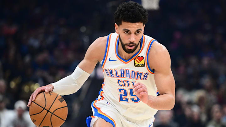 Jan 19, 2026; Cleveland, Ohio, USA; Oklahoma City Thunder guard Ajay Mitchell (25) brings the ball up court against the Cleveland Cavaliers during the first half at Rocket Arena. Mandatory Credit: Ken Blaze-Imagn Images