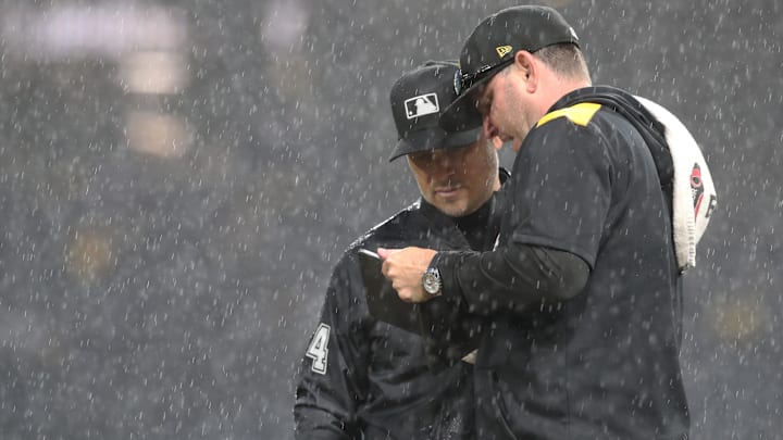 May 22, 2025; Pittsburgh, Pennsylvania, USA; Pittsburgh Pirates grounds crew chief Mattt Brown (right) talks with MLB umpire crew chief Mark Wegner (14) as a heavy rain delays the game against the Milwaukee Brewers in the sixth inning at PNC Park. Mandatory Credit: Charles LeClaire-Imagn Images May 22, 2025; Pittsburgh, Pennsylvania, USA; Pittsburgh Pirates grounds crew chief Mattt Brown (right) talks with MLB umpire crew chief Mark Wegner (14) as a heavy rain delays the game against the Milwaukee Brewers in the sixth inning at PNC Park. Mandatory Credit: Charles LeClaire-Imagn Images