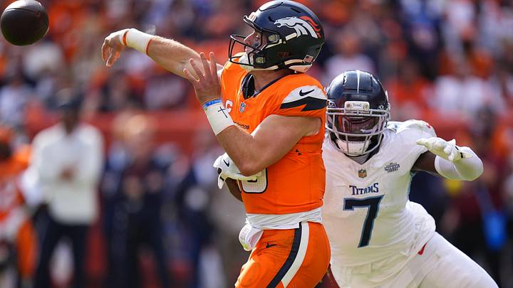 Sep 7, 2025; Denver, Colorado, USA; Denver Broncos quarterback Bo Nix (10) throws the ball past Tennessee Titans linebacker Oluwafemi Oladejo (7) in the second half at Empower Field at Mile High. Mandatory Credit: Ron Chenoy-Imagn Images