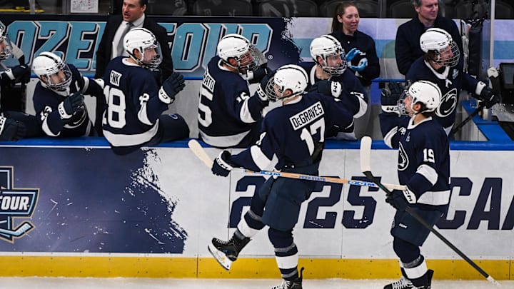 Penn State Nittany Lions forward Nicholas DeGraves (17) celebrates with teammates after scoring a goal against the Boston University Terriers during the NCAA Frozen Four. 