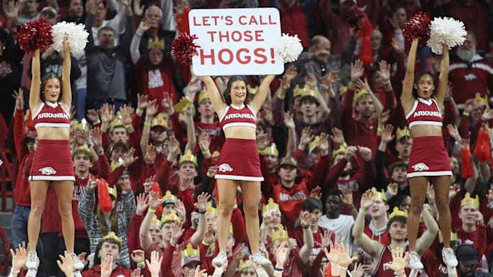 Jan 11, 2025; Fayetteville, Arkansas, USA; Arkansas Razorbacks fans and cheerleaders “call the hogs” during the second half against the Florida Gators at Bud Walton Arena. Florida won 71-63. Mandatory Credit: Nelson Chenault-Imagn Images