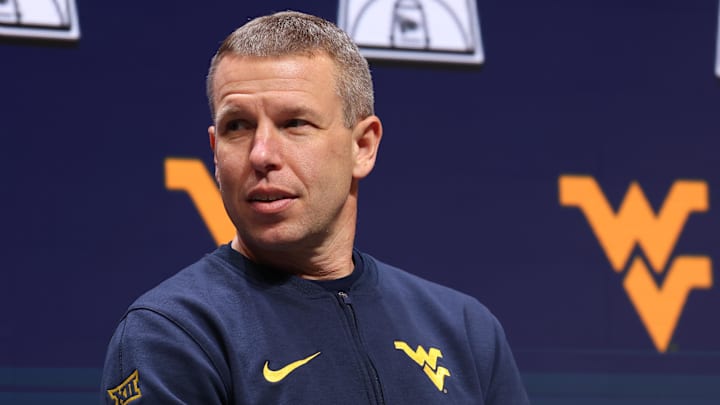 Oct 22, 2025; Kansas City, MO, USA; West Virginia head coach Ross Hodge speaks to media during Big 12 Menís Basketball media day at T-Mobile Center. Mandatory Credit: Sophia Scheller-Imagn Images Oct 22, 2025; Kansas City, MO, USA; West Virginia head coach Ross Hodge speaks to media during Big 12 Menís Basketball media day at T-Mobile Center. Mandatory Credit: Sophia Scheller-Imagn Images