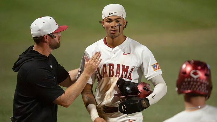 June 6, 2026; Tuscaloosa, AL, USA; Alabama head coach Rob Vaughn claps Alabama batter Justin Lebron (1) on the shoulder during a pitching change during the NCAA Tuscaloosa Super Regional game between Alabama and St. John’s at Sewell-Thomas Stadium. Alabama won game one of the series 8-0. June 6, 2026; Tuscaloosa, AL, USA; Alabama head coach Rob Vaughn claps Alabama batter Justin Lebron (1) on the shoulder during a pitching change during the NCAA Tuscaloosa Super Regional game between Alabama and St. John’s at Sewell-Thomas Stadium. Alabama won game one of the series 8-0.
