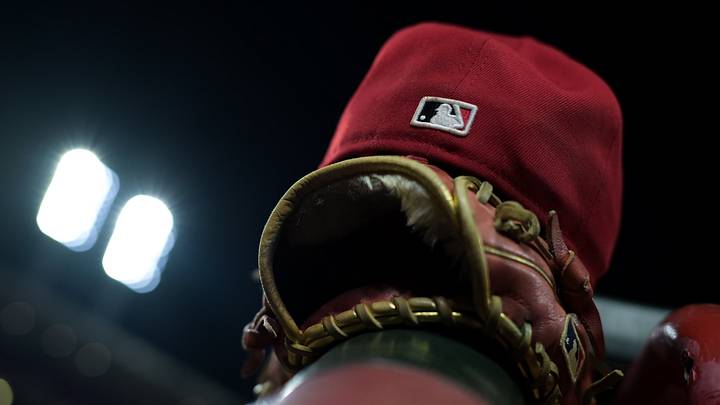 Aug 31, 2026; Cincinnati, Ohio, USA; The MLB logo on the field hat of a Cincinnati Reds player is seen resting on the dugout railing during the game against the San Diego Padres at Great American Ball Park. Mandatory Credit: Aaron Doster-Imagn Images Aug 31, 2026; Cincinnati, Ohio, USA; The MLB logo on the field hat of a Cincinnati Reds player is seen resting on the dugout railing during the game against the San Diego Padres at Great American Ball Park. Mandatory Credit: Aaron Doster-Imagn Images