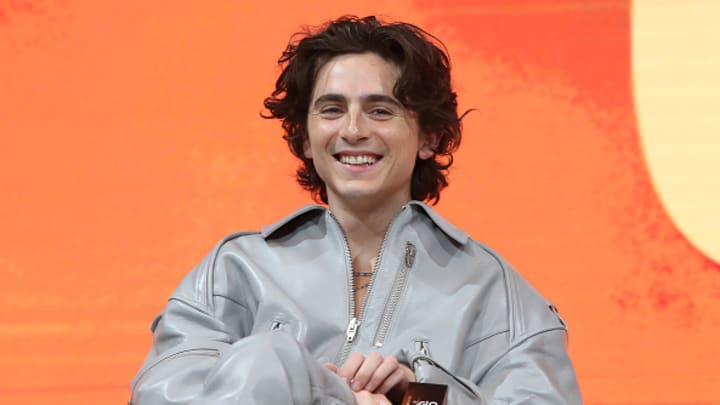 Actor Timothee Chalamet sits at a press conference for "Dune: Part Two."