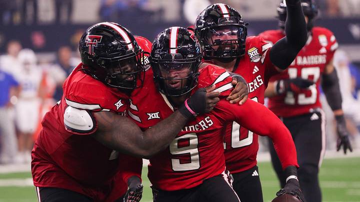 Lee Hunter (left) and Jacob Rodriguez (back) celebrate Romello Height's fumble recovery against BYU during the Big 12 Conference championship Lee Hunter (left) and Jacob Rodriguez (back) celebrate Romello Height's fumble recovery against BYU during the Big 12 Conference championship