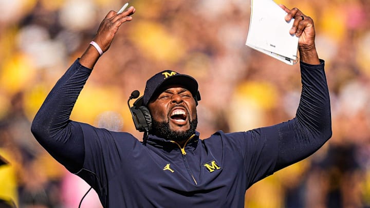 Michigan head coach Sherrone Moore cheers on before a play against Washington during the first half at Michigan Stadium in Ann Arbor on Saturday, Oct. 18, 2025.