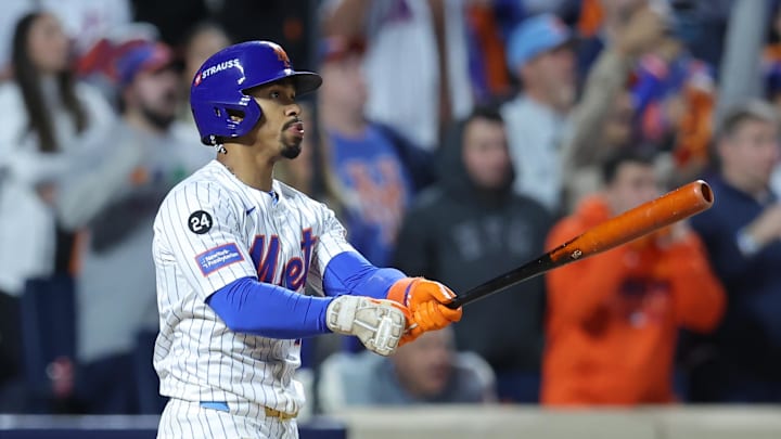 Oct 9, 2024; New York, New York, USA; New York Mets shortstop Francisco Lindor (12) hits a grand slam against the Philadelphia Phillies in the sixth inning in game four of the NLDS for the 2024 MLB Playoffs at Citi Field. Mandatory Credit: Brad Penner-Imagn Images