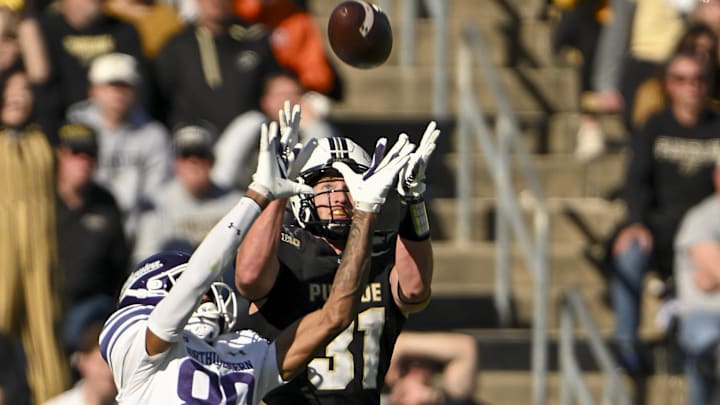 Dillon Thieneman goes up to stop a pass to Northwestern receiver Hayden Eligon II last season for Purdue.