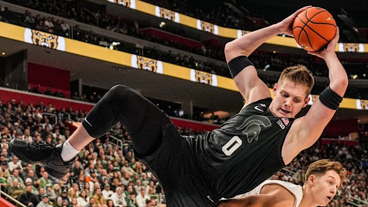 Michigan State Spartans forward Jaxon Kohler (0) is fouled by Oakland Golden Grizzlies guard Nassim Mashhour (0), during the first period at Little Caesars Arena in Detroit on Tuesday, Dec. 17, 2024.