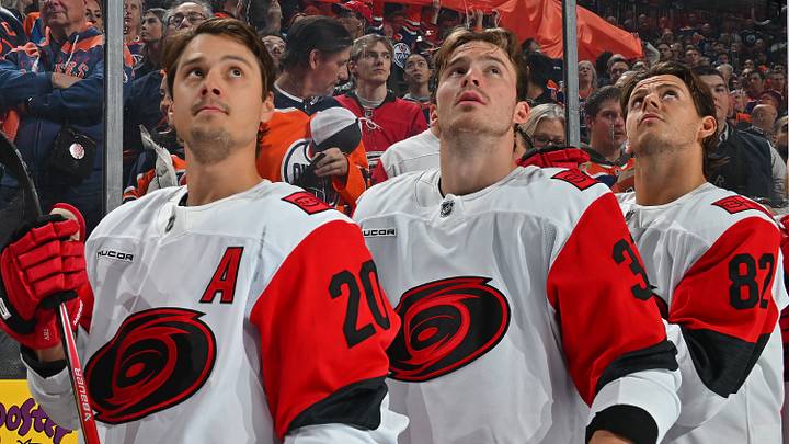 October 22, 2026: Sebastian Aho (20), Andrei Svechnikov (37), and Jesperi Kotkaniemi (82) stand during the national anthems ahead of their contest at Rogers Place in Edmonton, Alberta, Canada.