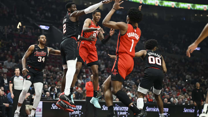 Apr 12, 2024; Portland, Oregon, USA; Houston Rockets forward Jabari Smith Jr. (10) passes the ball during the first half to forward Amen Thompson (1) against Portland Trail Blazers center Deandre Ayton (2) at Moda Center. Mandatory Credit: Troy Wayrynen-USA TODAY Sports