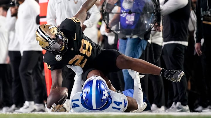 Vanderbilt running back Sedrick Alexander (28) is stopped by Kentucky defensive back Ty Bryant (14) during the third quarter at FirstBank Stadium in Nashville, Tenn., Saturday, Nov. 22, 2025.