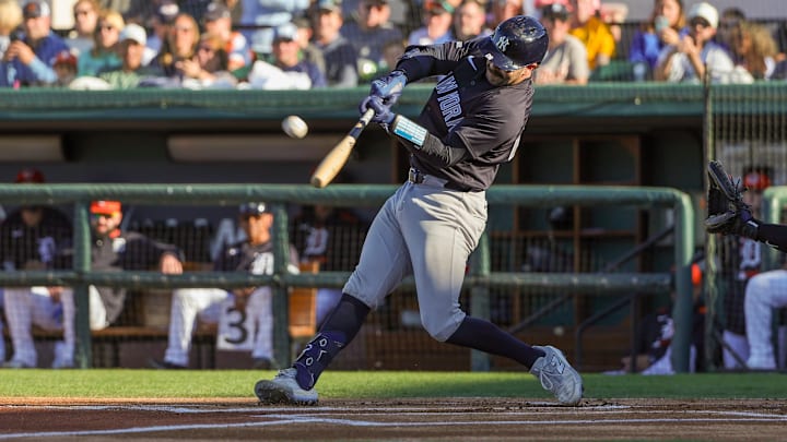 Mar 21, 2025; Lakeland, Florida, USA; New York Yankees catcher Austin Wells (28) hits a home run during the first inning against the Detroit Tigers at Publix Field at Joker Marchant Stadium. 