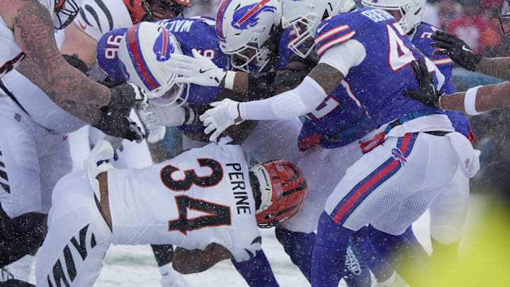 Cincinnati Bengals running back Samaje Perine heads into a wall of Bills players, including defensive tackle Deone Walker, during first-half action at Highmark Stadium in Orchard Park on Dec. 7, 2025.