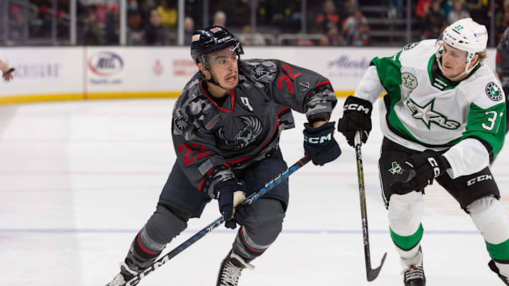 Andrew Poturalski (22) controls the puck during the game against the Texas Stars at Acrisure Arena