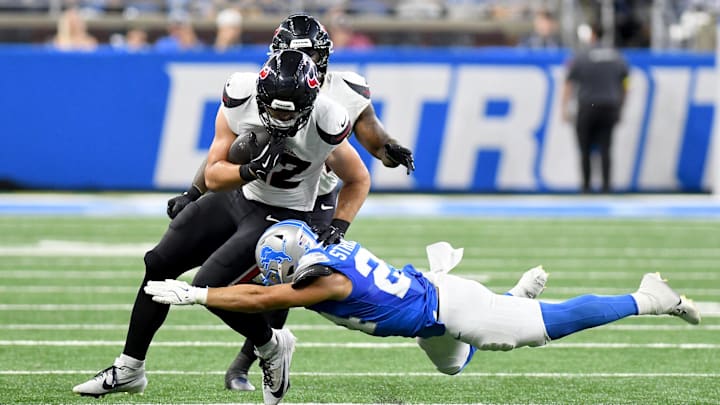 Aug 23, 2025; Detroit, Michigan, USA; Houston Texans tight end Luke Lachey (42) gets tackled by Detroit Lions safety Loren Strickland (24) in third quarter at Ford Field. Mandatory Credit: Eamon Horwedel-Imagn Images
